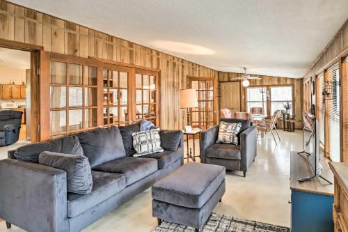 a living room with a couch and two chairs at 40-Acre Poplar Bluff Nature Lovers Paradise! in Poplar Bluff