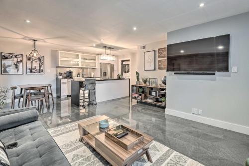 a living room with a couch and a table at Walk to Fashion Square! Snowbird Condo with Pool in Scottsdale