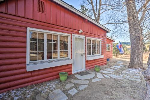 a red house with two windows and a door at Wildmanor Ranch Near Red Rocks with Hot Tub! in Morrison