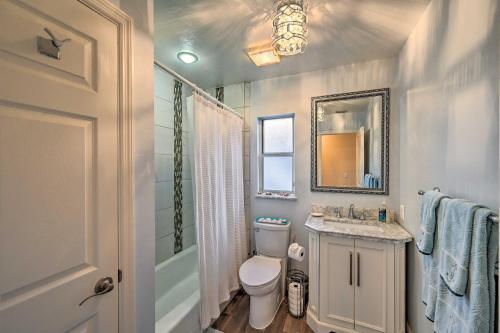 a bathroom with a toilet and a sink and a mirror at House with Heated Pool and Grill - Walk to Beach! in Marco Island