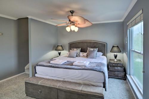 a bedroom with a bed and a ceiling fan at Waterfront San Jacinto River Home with Boat Slip! in Houston