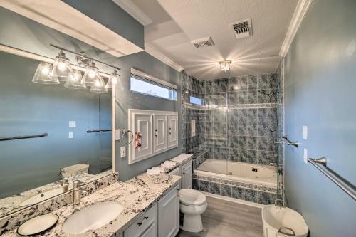 a bathroom with two sinks and a tub and a toilet at Waterfront San Jacinto River Home with Boat Slip! in Houston
