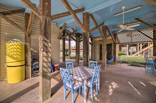 a patio with a table and chairs and a ceiling at Waterfront San Jacinto River Home with Boat Slip! in Houston