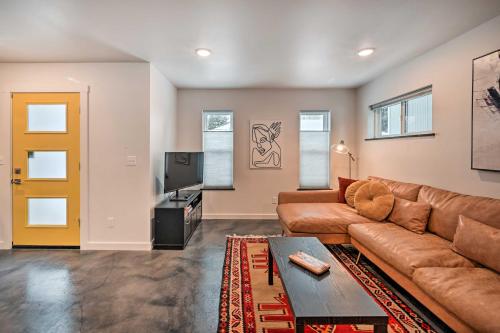 a living room with a brown couch and a tv at Modern Missoula Home about 2 Miles to Downtown! in Missoula