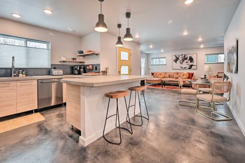 a kitchen with a large island with bar stools at Modern Missoula Home about 2 Miles to Downtown! in Missoula