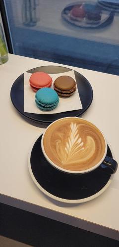 a cup of coffee and cookies on a table at Wyndham Garden Christchurch Kilmore Street in Christchurch