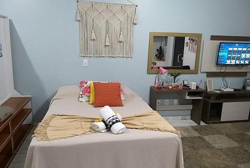 a bedroom with a bed and a desk with a computer at loft harmonia in Blumenau