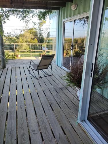 a rocking chair on a porch with a sliding glass door at Naturaleza pura in Rocha