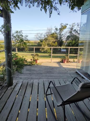 a wooden deck with a bench and a fence at Naturaleza pura in Rocha