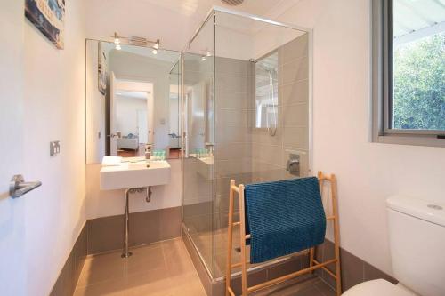 a bathroom with a glass shower and a sink at Blue Haven Margaret River tranquil bush retreat in Margaret River Town