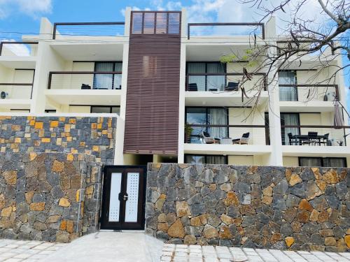 a building with a gate and a stone wall at Superbe apt 2 chambres Mont Choisy Beach by Lov in Mont Choisy