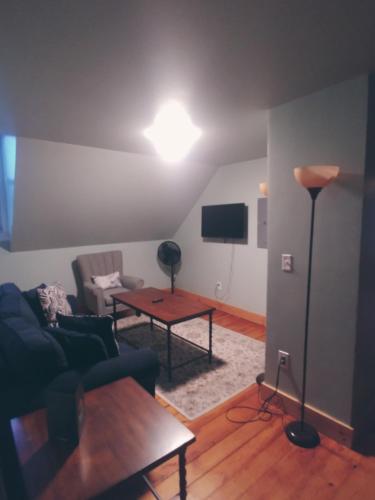 a living room with a couch and a table at Back Cove Views in Portland
