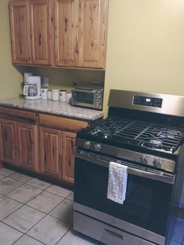 a kitchen with a black stove and wooden cabinets at Back Cove Views in Portland