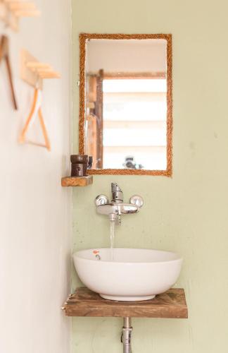 a bathroom with a sink and a mirror at The Kadupul Homecation in Da Lat