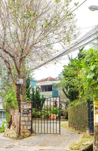 a gate with a sign on it next to a tree at The Kadupul Homecation in Da Lat