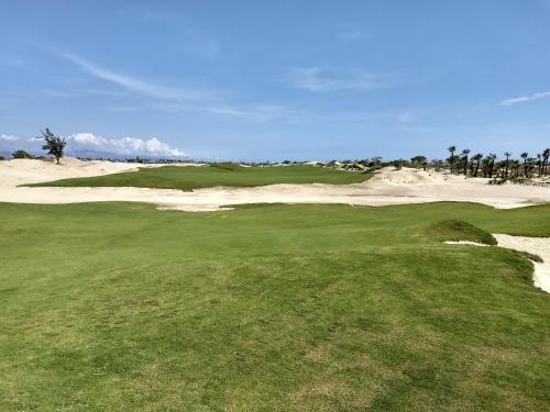 a view of a golf course with a green and a sand bunker at The O'asis in La Ribera