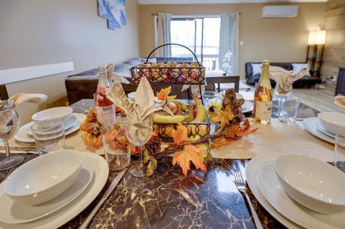 a dining room table with plates and wine glasses and a centerpiece at Pocono Paradise 143, NEW 4bd, Tannersville, Camelback, Kalahari in Tannersville