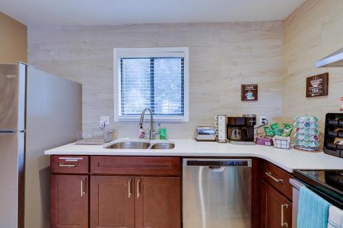 a kitchen with a sink and a refrigerator at Pocono Paradise 143, NEW 4bd, Tannersville, Camelback, Kalahari in Tannersville