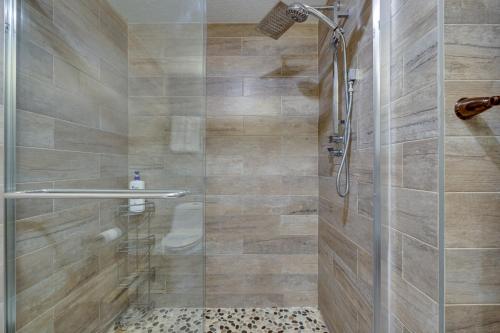 a bathroom with a shower with a glass door at Pocono Paradise 143, NEW 4bd, Tannersville, Camelback, Kalahari in Tannersville