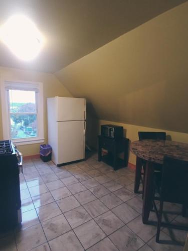 a kitchen with a white refrigerator and a table at Back Cove Views in Portland