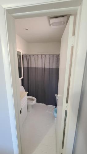 a bathroom with a toilet and a shower at Beautiful Casa Del Sol in Hollywood