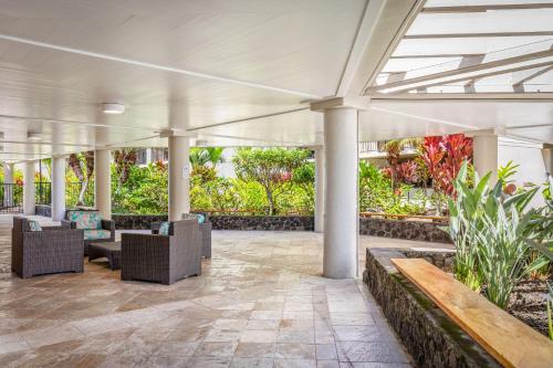 an empty lobby with chairs and plants at Aston Kona By The Sea in Kailua-Kona