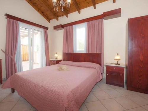 a bedroom with a large bed with a pink blanket at L'eremo Luxury Messonete in Roda