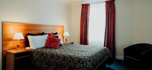 a hotel room with a bed and a window at Stanley Hotel in Stanley