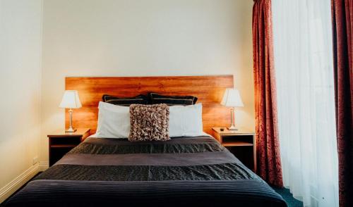 a hotel room with a bed with two lamps at Stanley Hotel in Stanley
