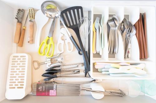 a drawer filled with utensils on top of a counter at Seaside House Yasutaketei in Shirahama