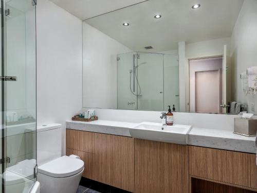 a bathroom with a sink and a toilet and a shower at Big Nanook Squatters 32 in Thredbo