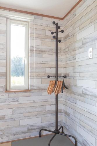 a room with a wall of wood paneling at Seaside House Yasutaketei in Shirahama