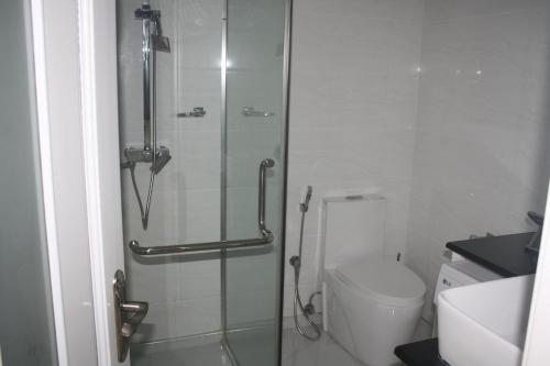 a bathroom with a shower and a toilet at Lovely Sea View Apartment in Colombo
