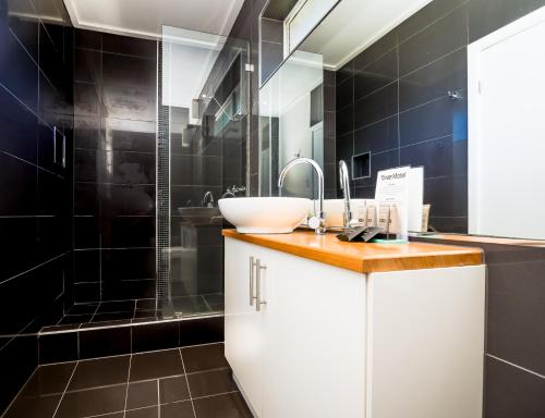 a bathroom with a sink and a shower at Tower Motel Marysville in Marysville