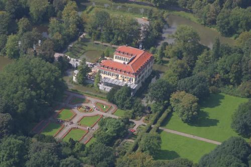 an aerial view of a large house with a garden at Schloss Berge in Gelsenkirchen