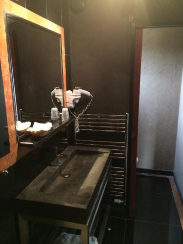 a bathroom with a sink and a large mirror at Hôtel Saint Alban in Saint-Maur-des-Fossés