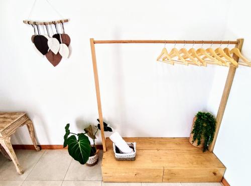 a room with a wooden bench and plants at PLAYA KARMA in Dalung