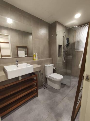 a bathroom with a sink and a toilet and a shower at TimurBay Seafront Holiday Pool & Seaview in Kuantan