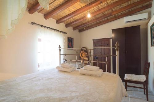 a bedroom with a large bed with towels on it at Olympia Traditional Houses in Lymbia