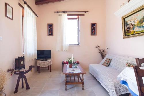 a living room with a couch and a table at Olympia Traditional Houses in Lymbia