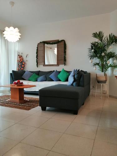 a living room with a couch and a table at Kings Palace Indigo 109 in Paphos
