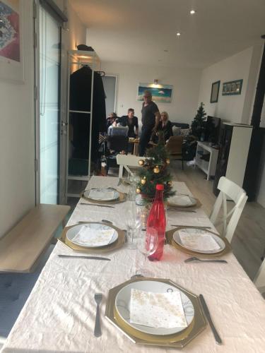 a table with a christmas tree in a living room at Kercady 2 in Audierne