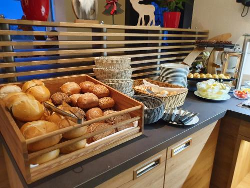 a table with a tray of bread and other foods at Hotel Waldrausch in Hahnenklee-Bockswiese