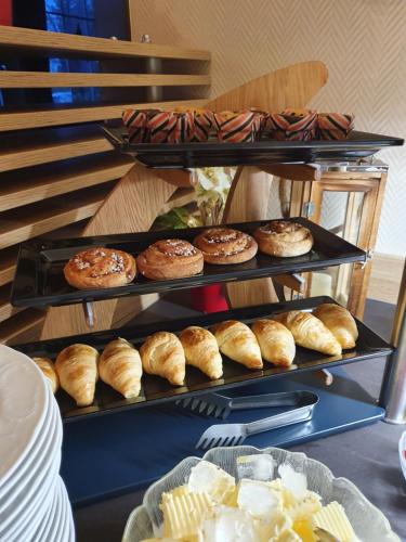 a display of breads and pastries on a shelf at Hotel Waldrausch in Hahnenklee-Bockswiese