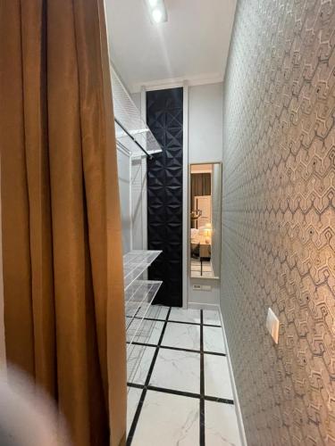 a hallway with a staircase and a shower in a house at Hotel BERGS in Sochi