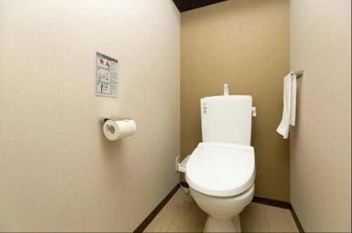 a bathroom with a toilet and a roll of toilet paper at Karasuma Rokujo Hotel / Vacation STAY 3036 in Kyoto