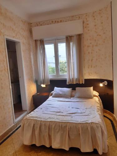 a bedroom with a large bed in front of a window at Hotel Messina in Mar del Plata
