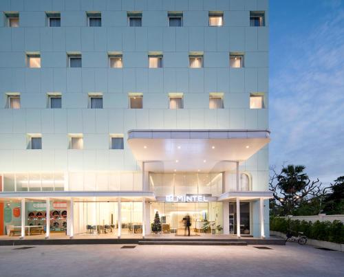 a large white building with a store front at Mintel Huamark in Bangkok