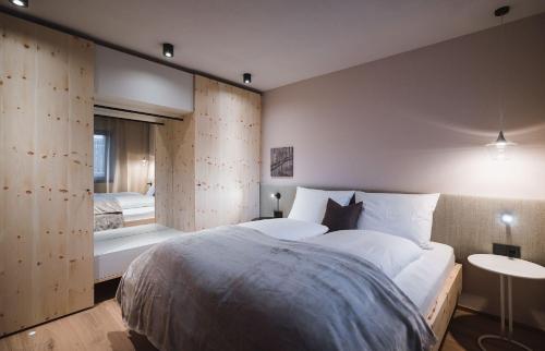 a bedroom with a large white bed and a window at AHRN Natur Apartment in Lutago