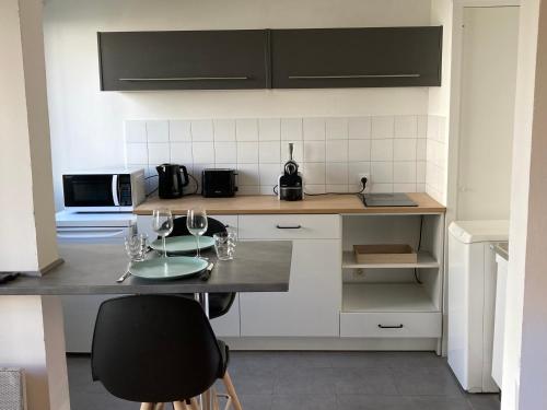 uma cozinha com um balcão com copos de vinho em Lumineux Studio 30m² sur Cour - Proche Tram/Centre em Nantes